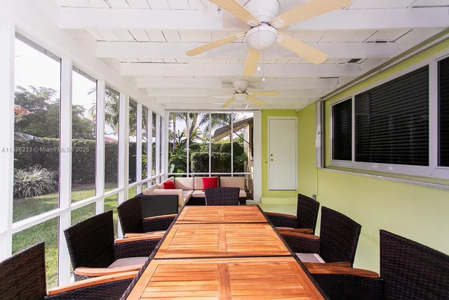 a view of a patio with a table chairs and a backyard
