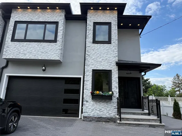 a front view of a house with a parking space