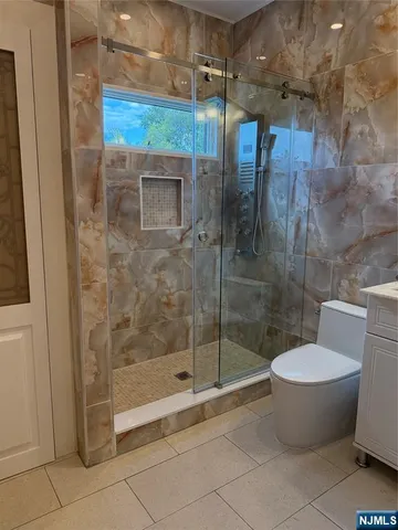 a bathroom with a shower and toilet