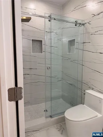 a bathroom with a toilet and a shower
