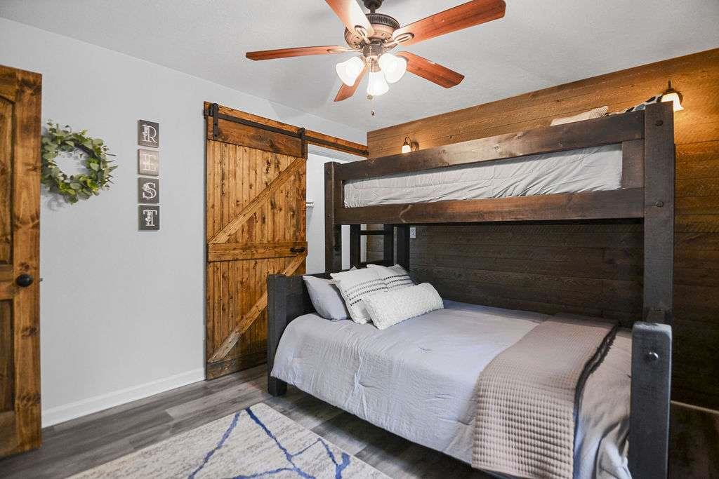 45 Wilderness Trail Blue Ridge, GA 30513 - Photo 23 of 52 a bedroom with a bed and a chandelier