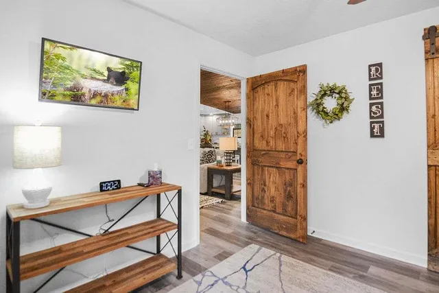 a bedroom with a bed and a chandelier