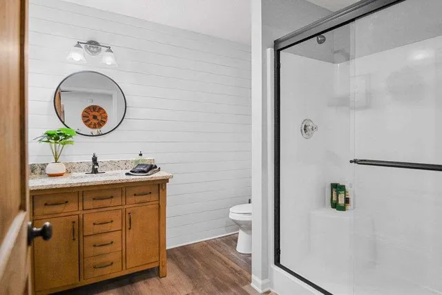 a bedroom with a bed and a ceiling fan