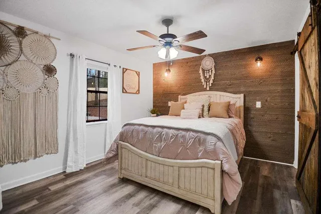 a bedroom with a large bed and a chandelier