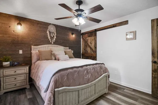 a bedroom with a bed and a chandelier
