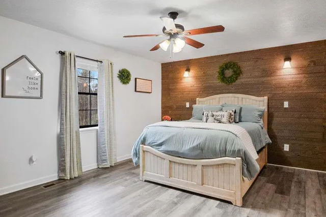 a bedroom with a bed and wooden floor