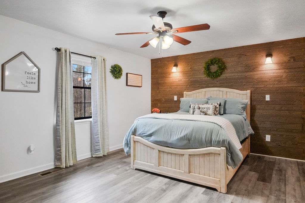 45 Wilderness Trail Blue Ridge, GA 30513 - Photo 29 of 52 a bedroom with a bed and a chandelier