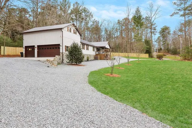 a view of a house with backyard and a tree
