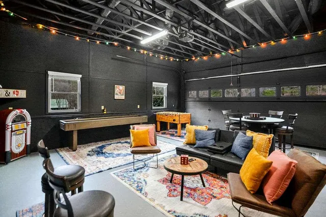 a living room with furniture a chandelier and a flat screen tv