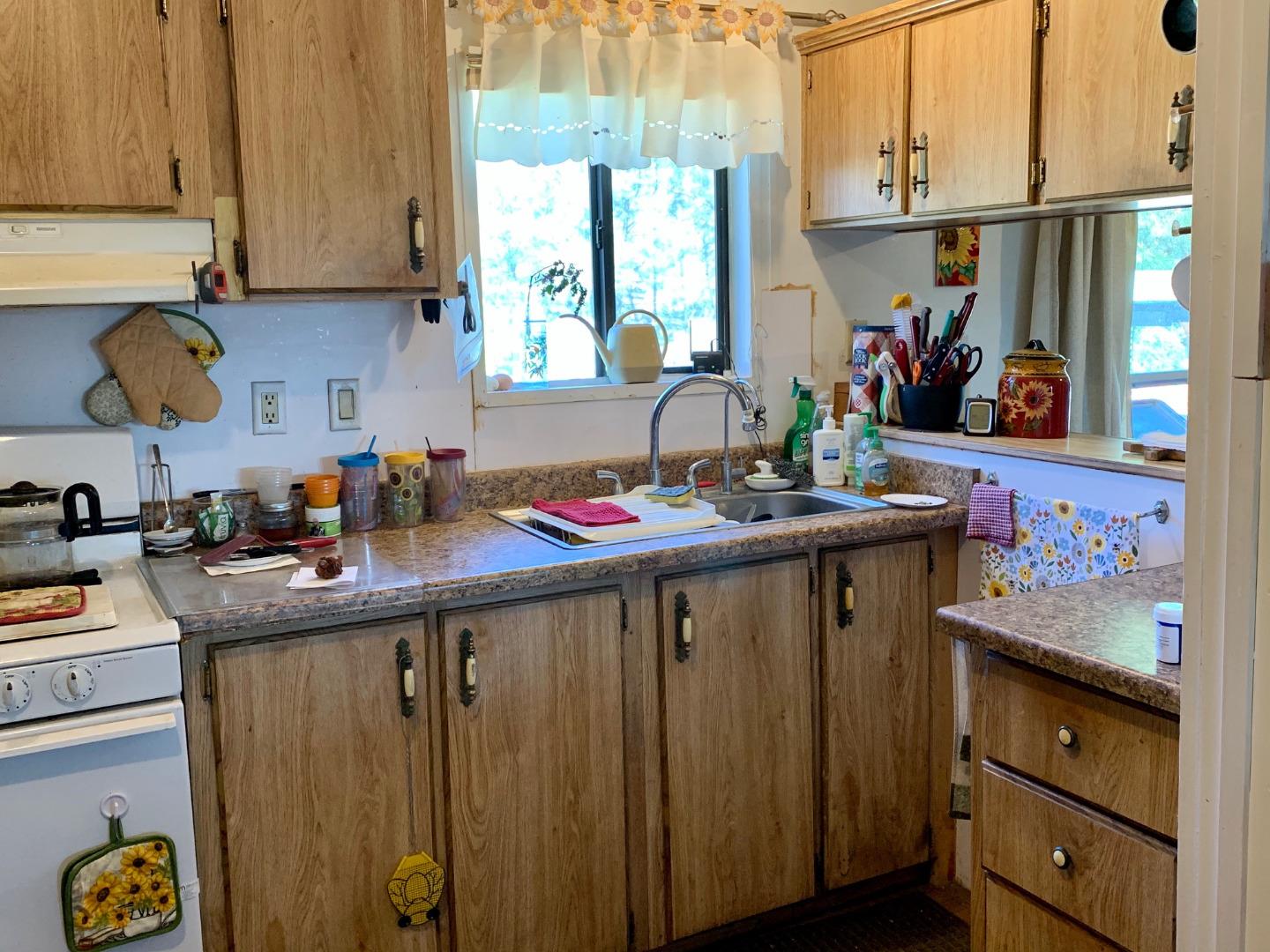 73856 Copperhead Road Bradley, CA 93426 - Photo 20 of 23 a kitchen with stainless steel appliances wooden cabinets and a table