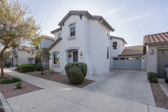 a view of a white house with a sink and a chairs