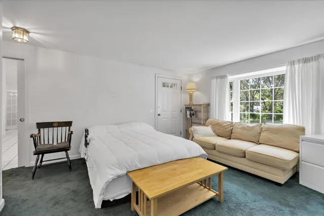 a bedroom with a bed and a couch