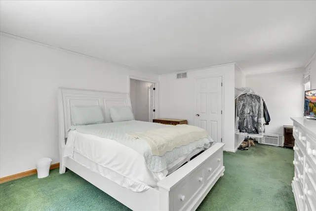 a bed room with a bed and a chair