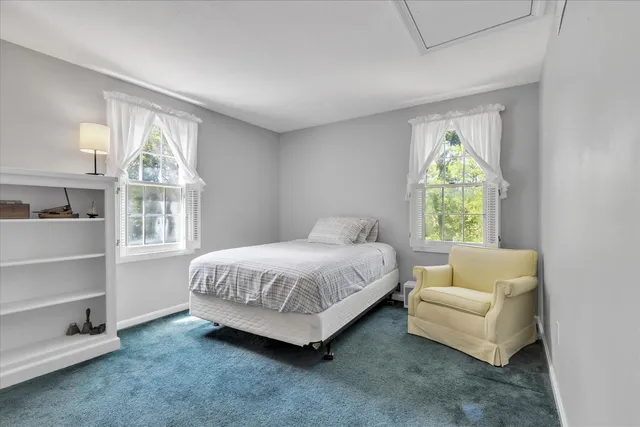 a spacious bedroom with a bed and a large window