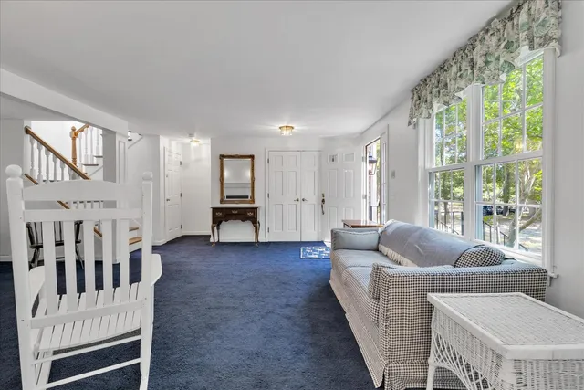 a living room with furniture and large windows