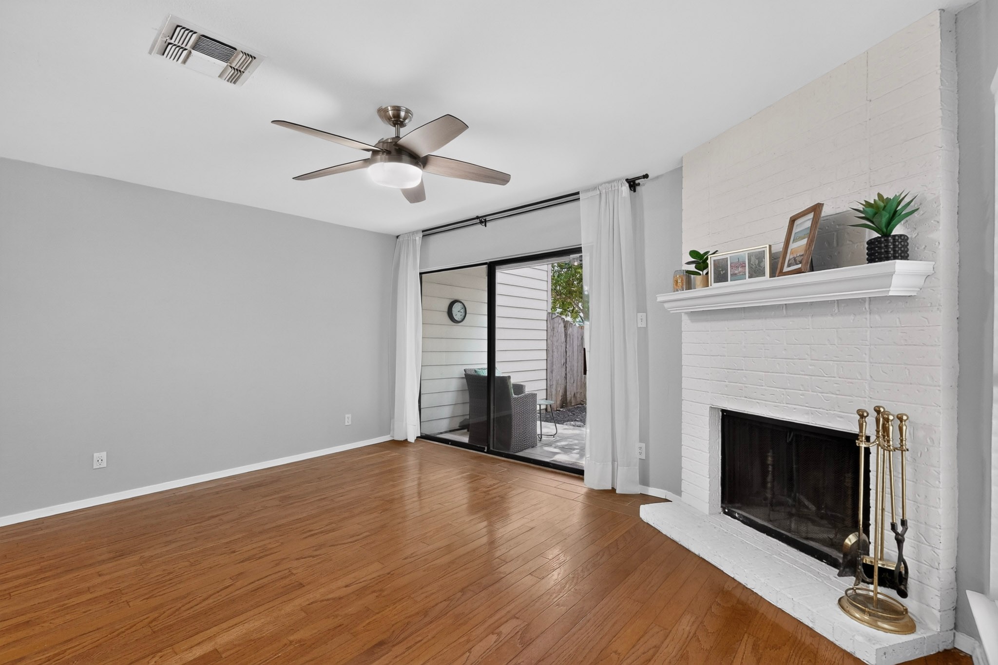 3801 Menchaca Road, Unit 25 Austin, TX 78704 - Photo 6 of 27 Living room - Hardwood floors, fireplace, private patio space