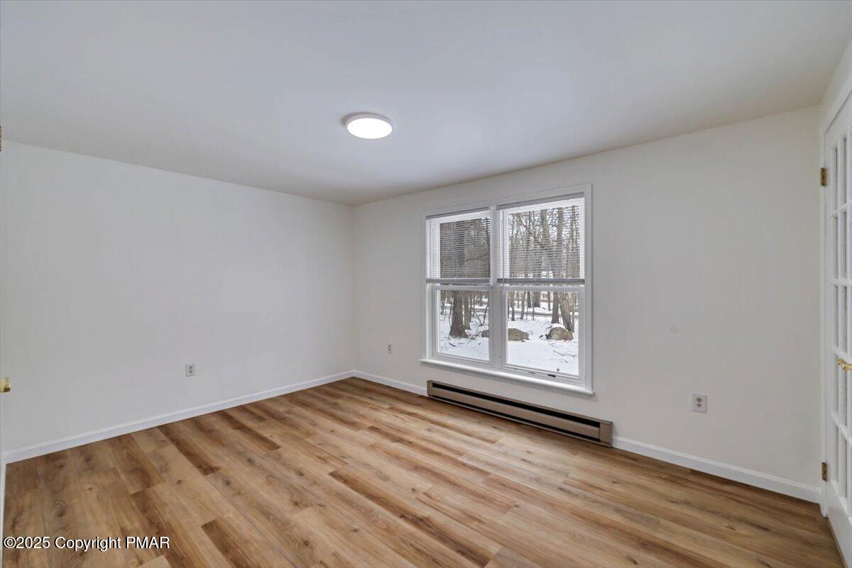 115 Daisy Drive Effort, PA 18330 - Photo 11 of 15 an empty room with wooden floor and windows