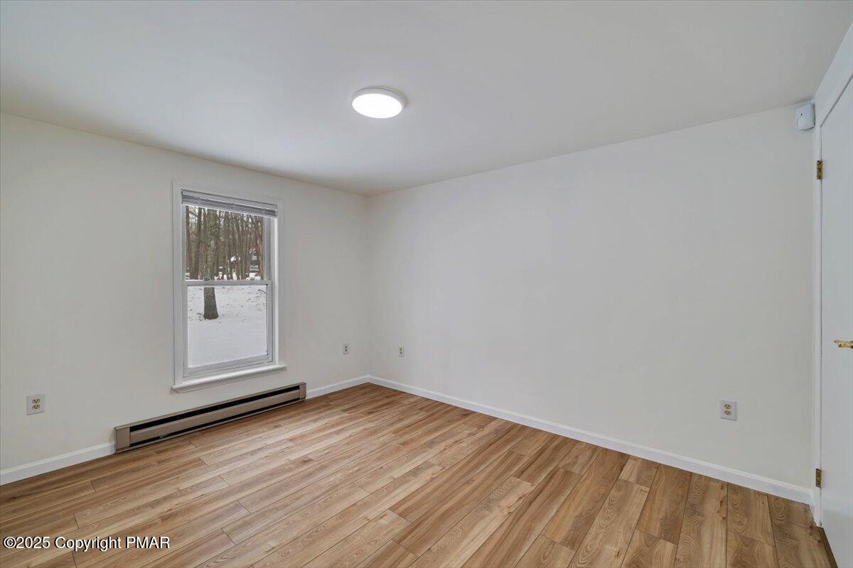 115 Daisy Drive Effort, PA 18330 - Photo 13 of 15 a view of an empty room with wooden floor and a window