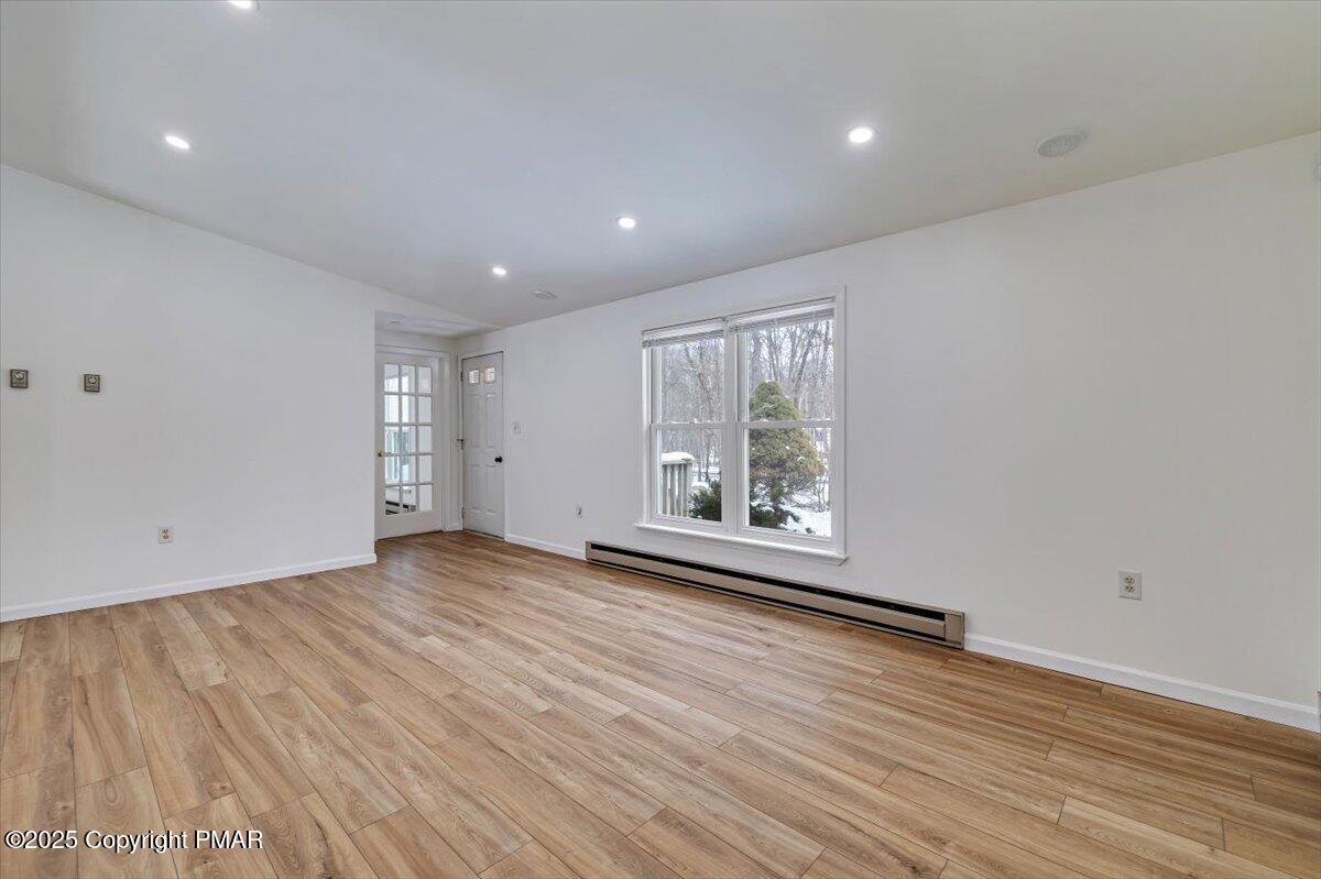 115 Daisy Drive Effort, PA 18330 - Photo 4 of 15 a view of an empty room with wooden floor and a window