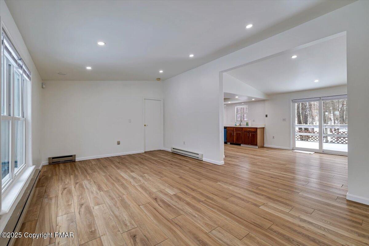 115 Daisy Drive Effort, PA 18330 - Photo 5 of 15 a view of empty room with wooden floor and kitchen view