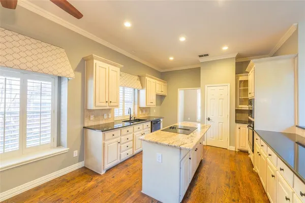 a large white kitchen with a large window