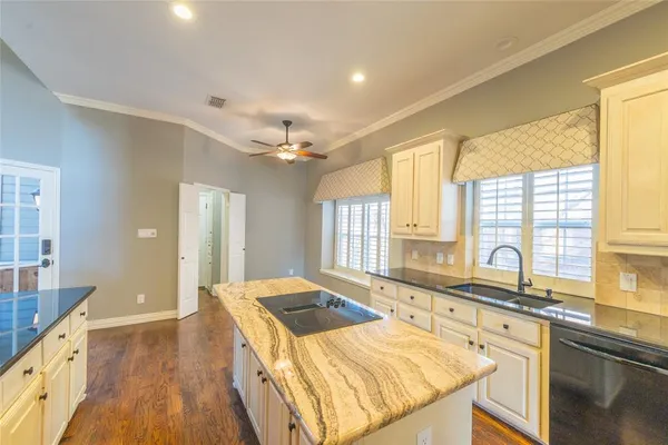 a kitchen with a sink and large windows
