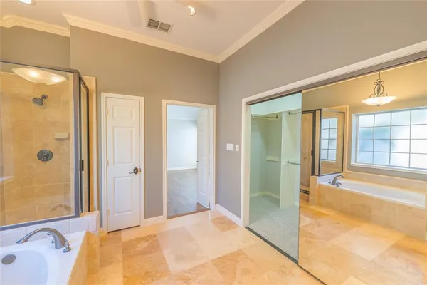a spacious bathroom with a tub shower and sink