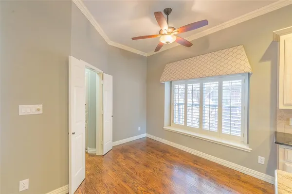 a view of a livingroom with a ceiling fan and window
