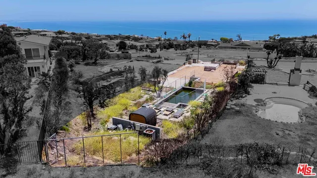 an aerial view of a house with a ocean view