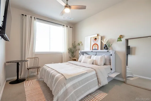 a bedroom with a bed and a large window