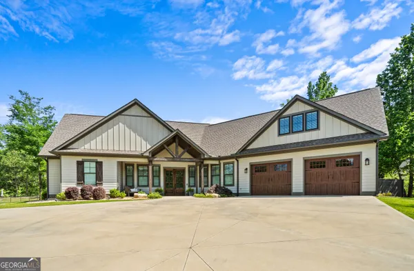a front view of a house with a garden