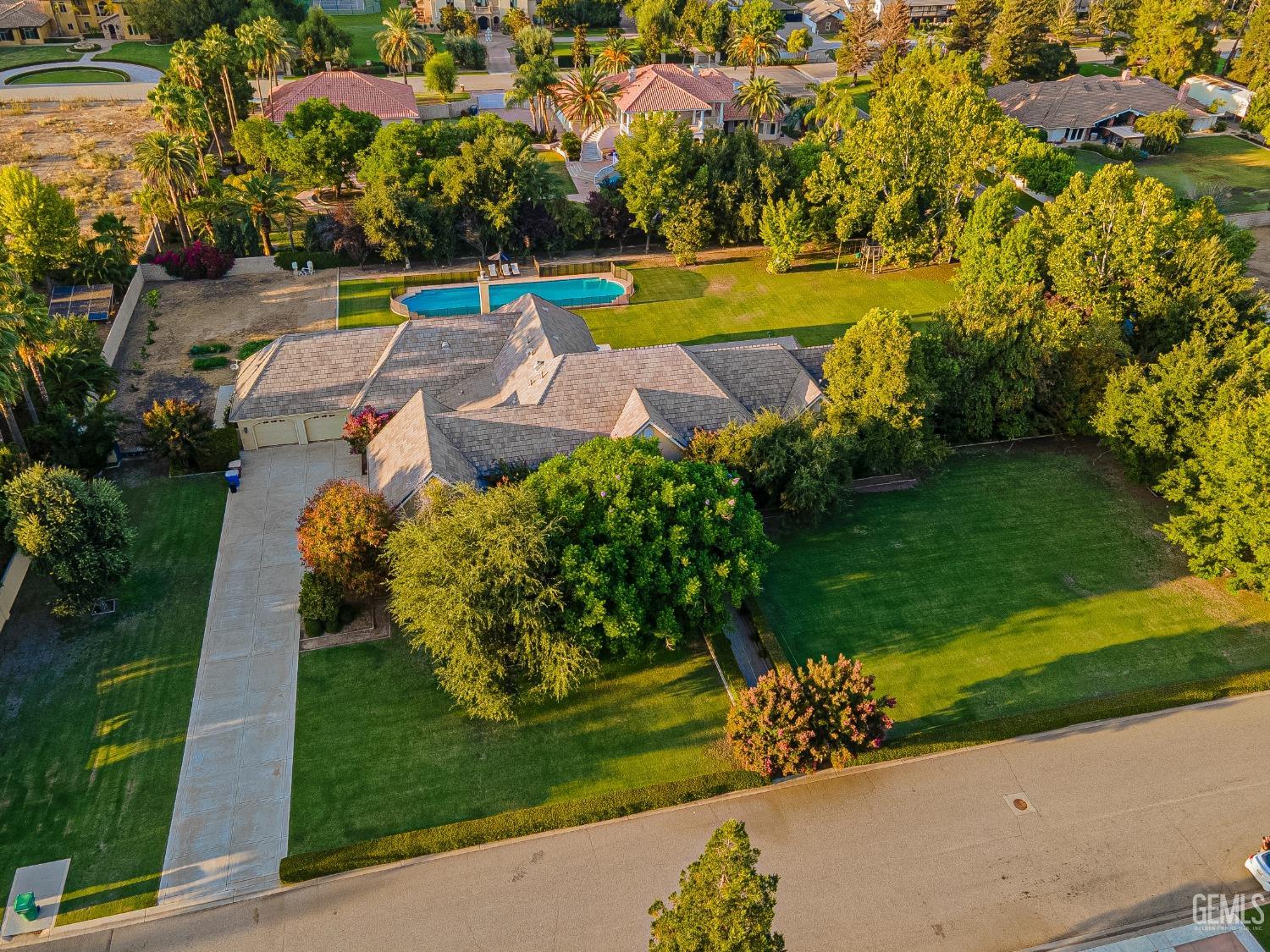 Undisclosed Address Bakersfield, CA 93314 - Photo 2 of 75 an aerial view of a house with a garden and swimming pool