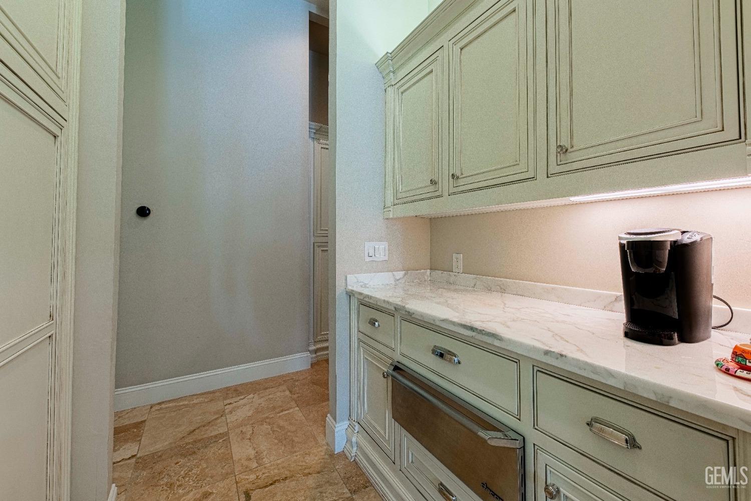 Undisclosed Address Bakersfield, CA 93314 - Photo 27 of 75 a kitchen with granite countertop cabinets and sink