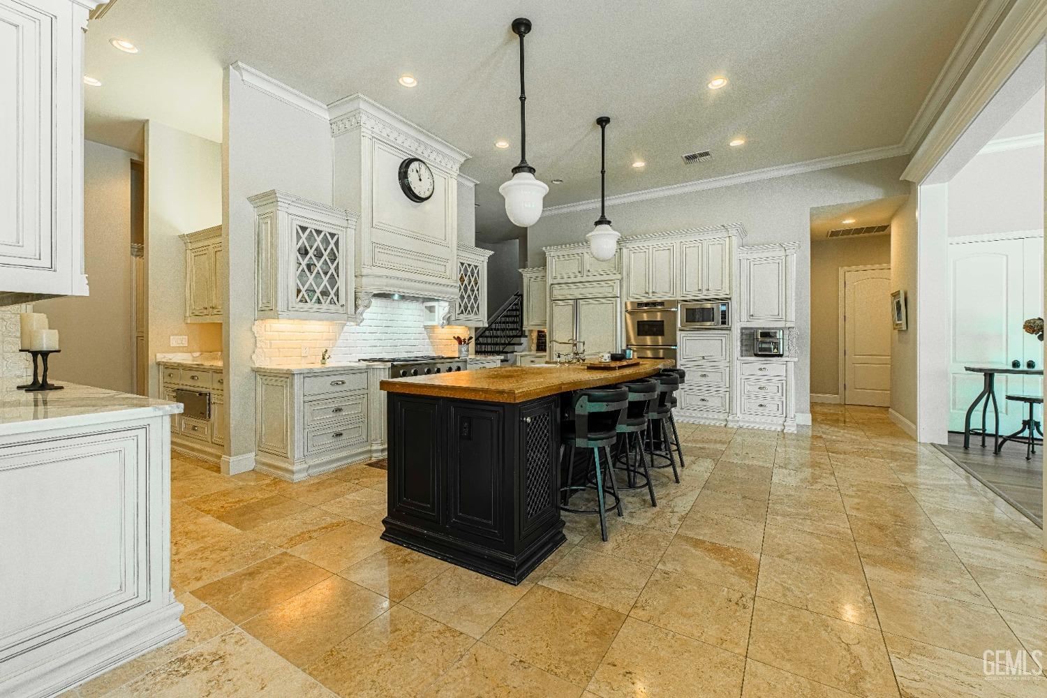 Undisclosed Address Bakersfield, CA 93314 - Photo 29 of 75 a kitchen with kitchen island granite countertop a sink and a refrigerator