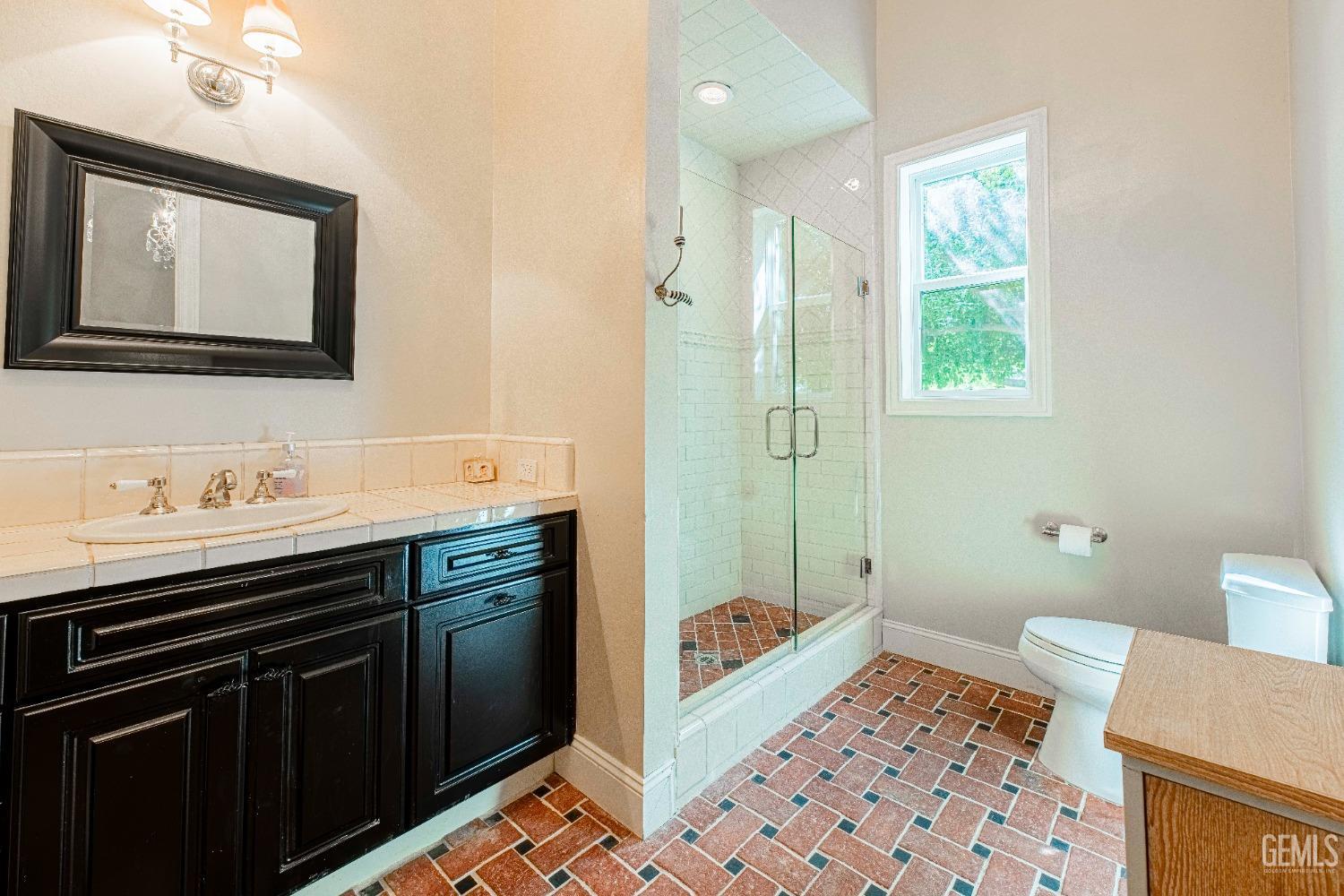 Undisclosed Address Bakersfield, CA 93314 - Photo 37 of 75 a bathroom with a sink a toilet and shower