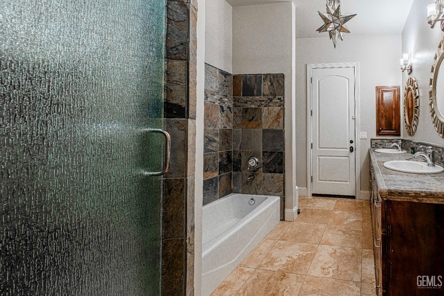 Undisclosed Address Bakersfield, CA 93314 - Photo 48 of 75 a bathroom with a granite countertop sink a mirror and shower