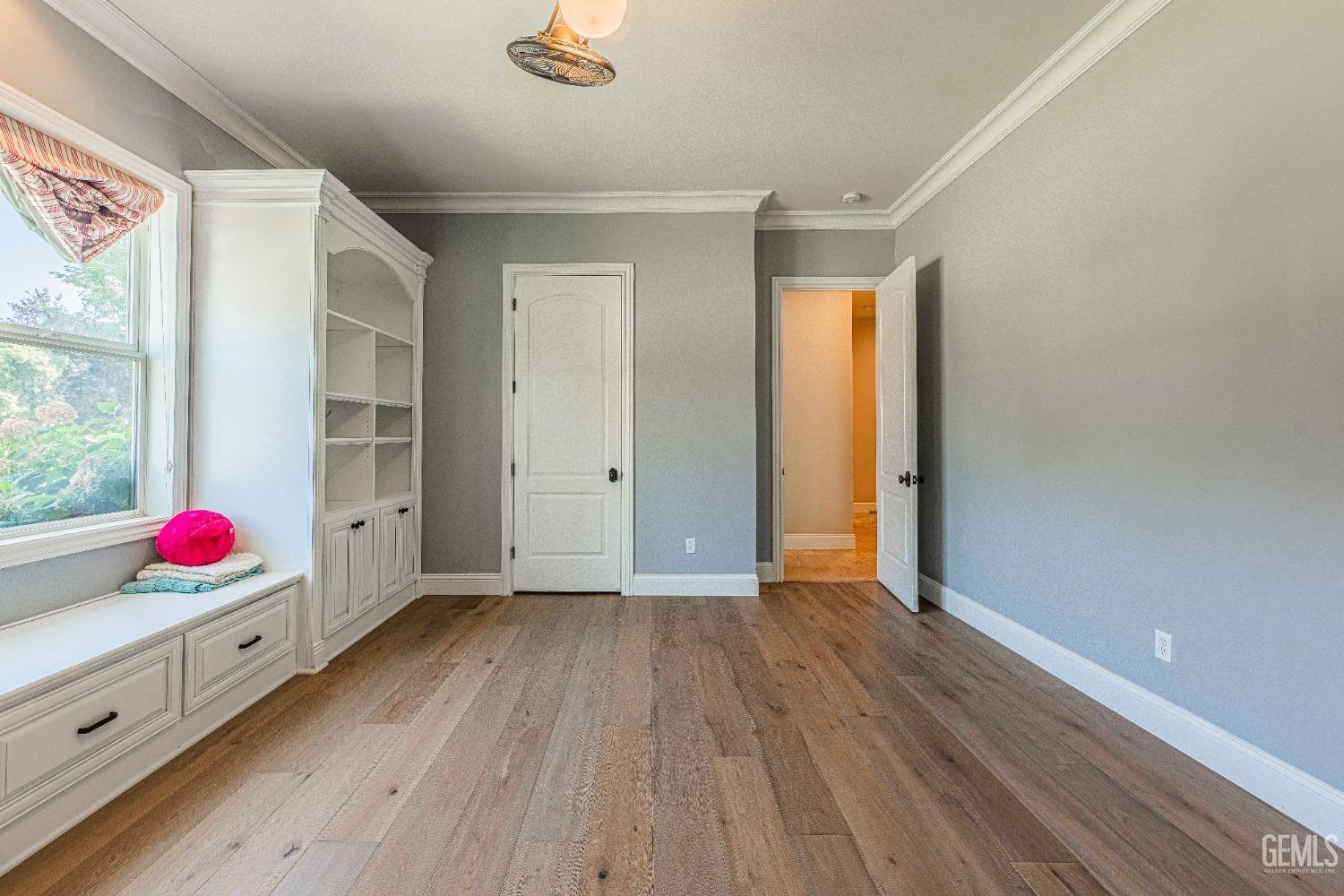 Undisclosed Address Bakersfield, CA 93314 - Photo 50 of 75 a view of an empty room with window and wooden floor