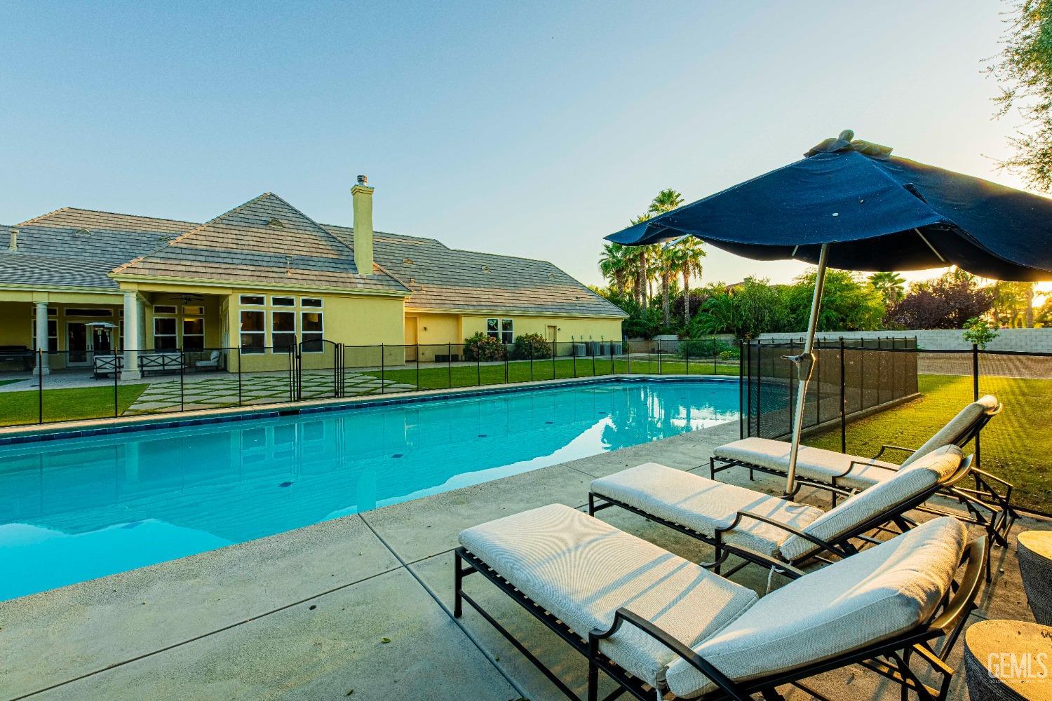 Undisclosed Address Bakersfield, CA 93314 - Photo 60 of 75 a patio with a table and chairs under an umbrella