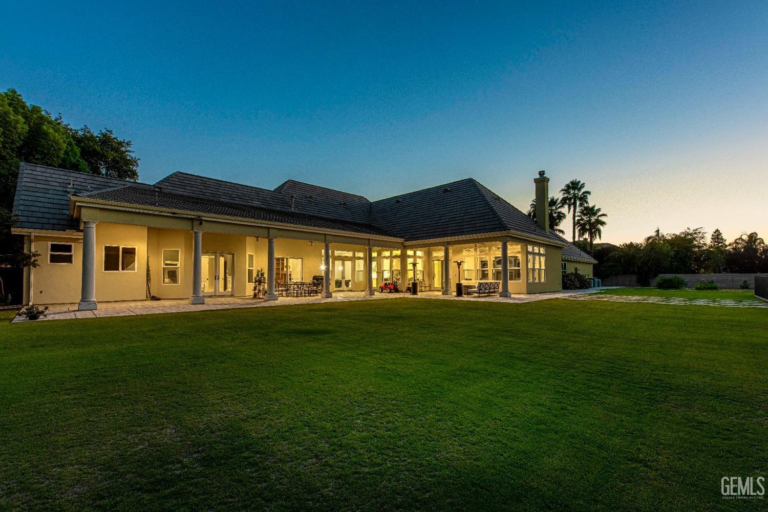 Undisclosed Address Bakersfield, CA 93314 - Photo 6 of 75 a front view of a house with a garden