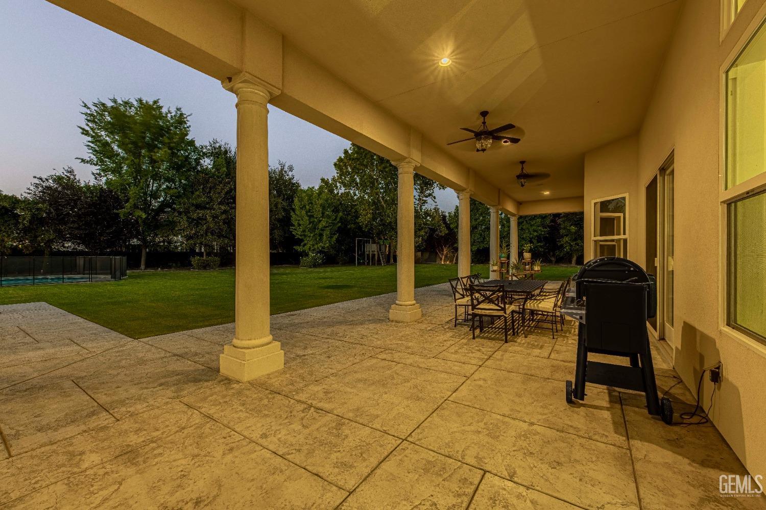 Undisclosed Address Bakersfield, CA 93314 - Photo 69 of 75 a view of a patio with a table and chairs
