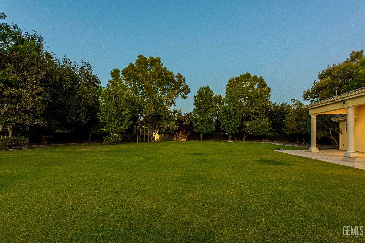 Undisclosed Address Bakersfield, CA 93314 - Photo 70 of 75 a backyard of a house with lots of green space