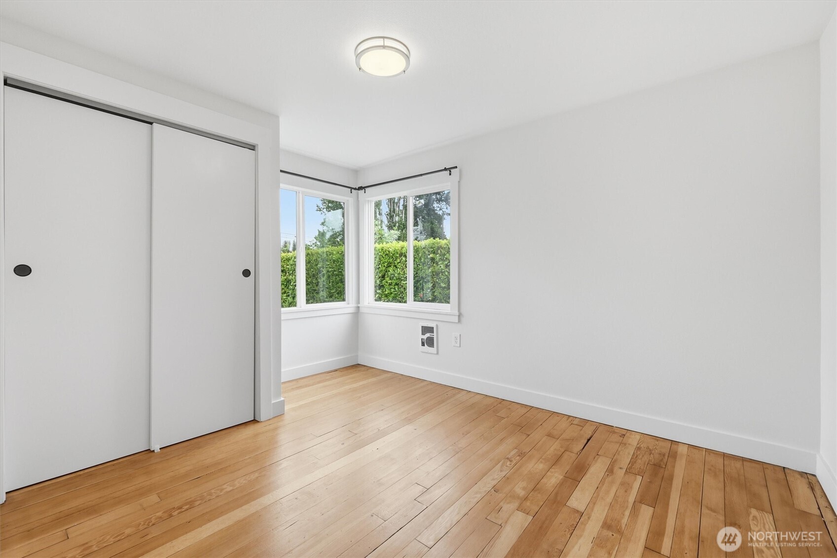 1651 Southwest 114th Street Seattle, WA 98146 - Photo 22 of 37 an empty room with wooden floor and windows