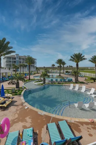 a view of a swimming pool with a yard