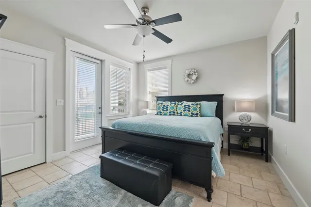 a bedroom with a bed and a ceiling fan