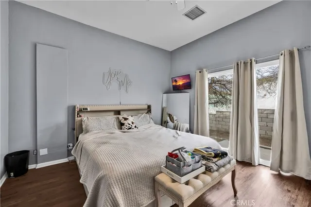 a bedroom with a bed and a flat tv screen