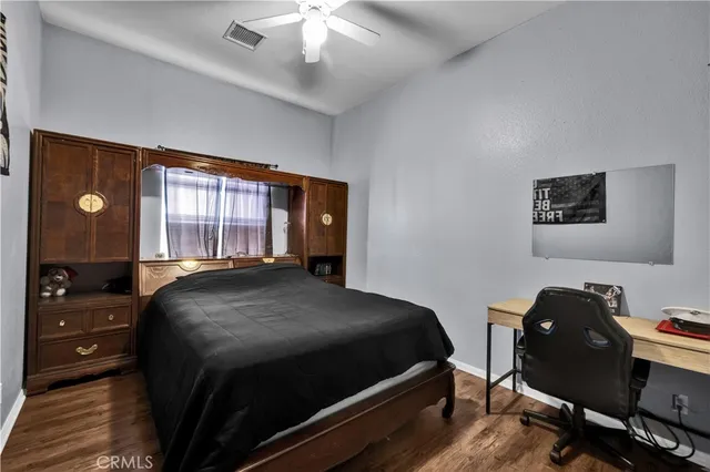 a bedroom with a bed and a television