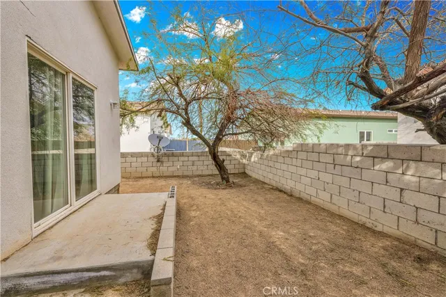 a living room with furniture and a refrigerator