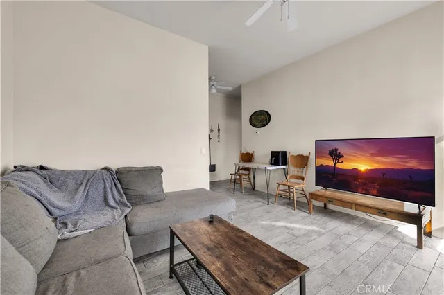 a living room with furniture a wooden floor and a sink