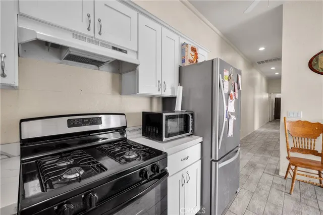 a bedroom with a bed next to a window and a lamp