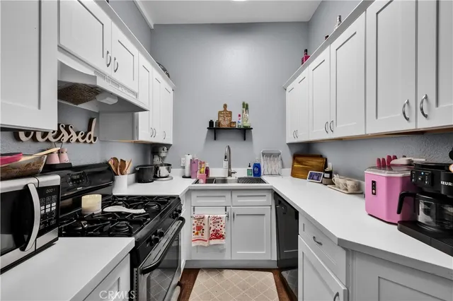 a kitchen with cabinets and window